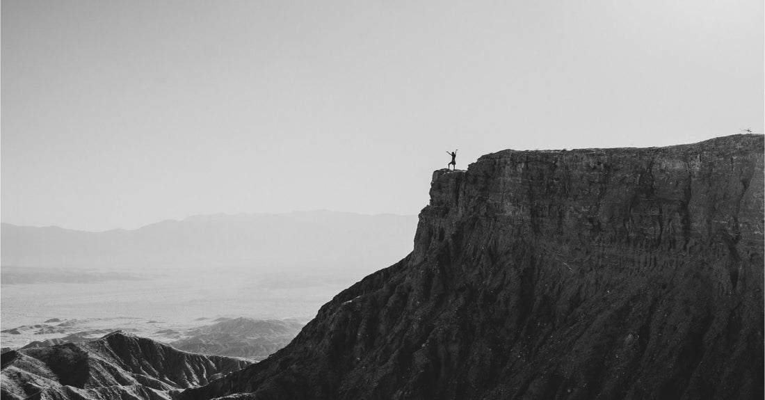 
  woman standing on a scenic cliff
