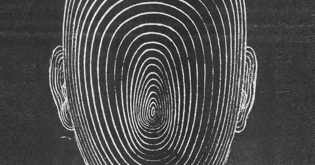Black and white drawing of a face and brain