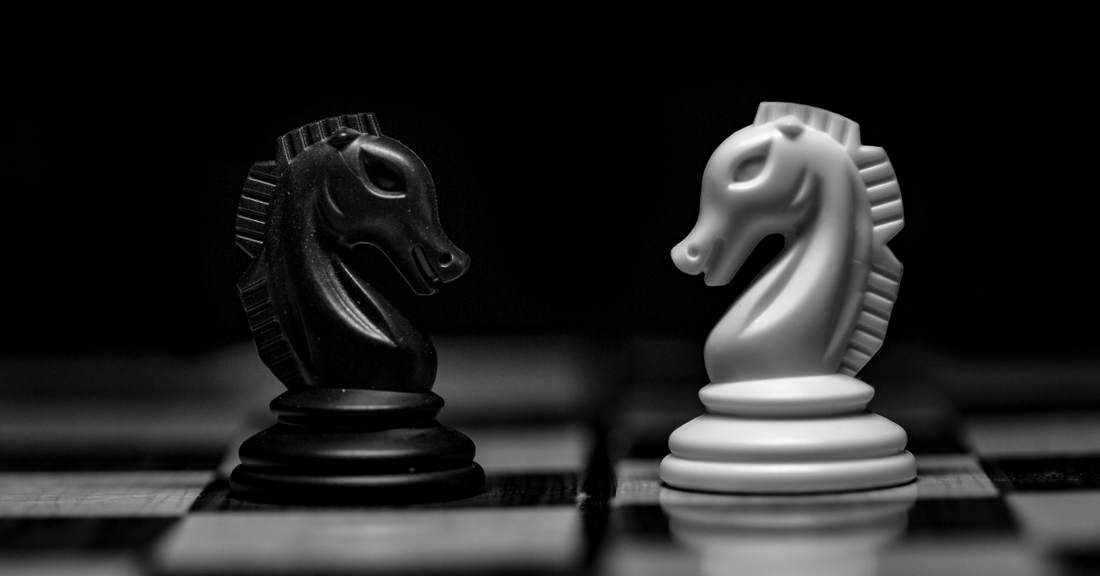 Two chess pieces facing eachother