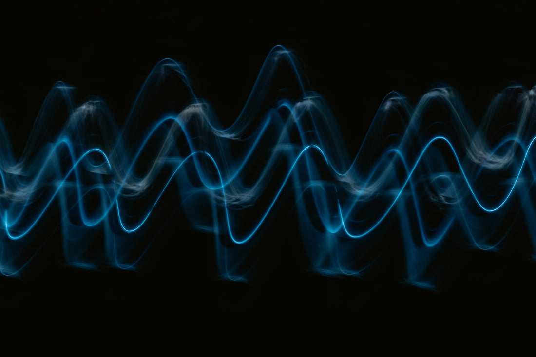 
  Blue sound waves against a black backdrop
