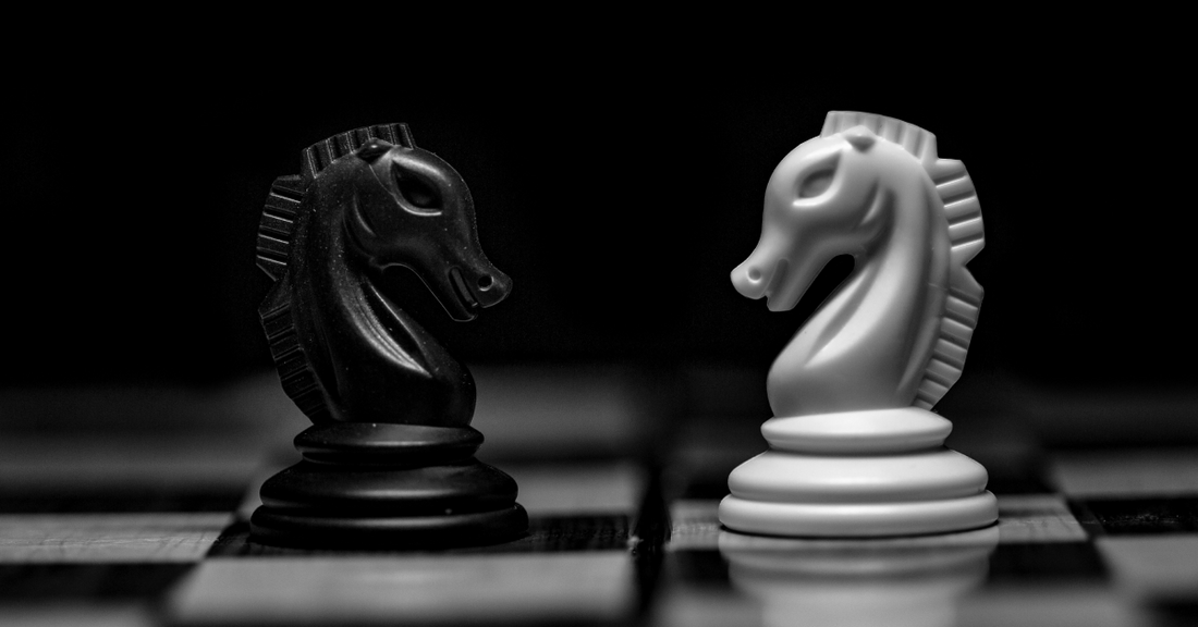 
  Two chess pieces facing eachother
